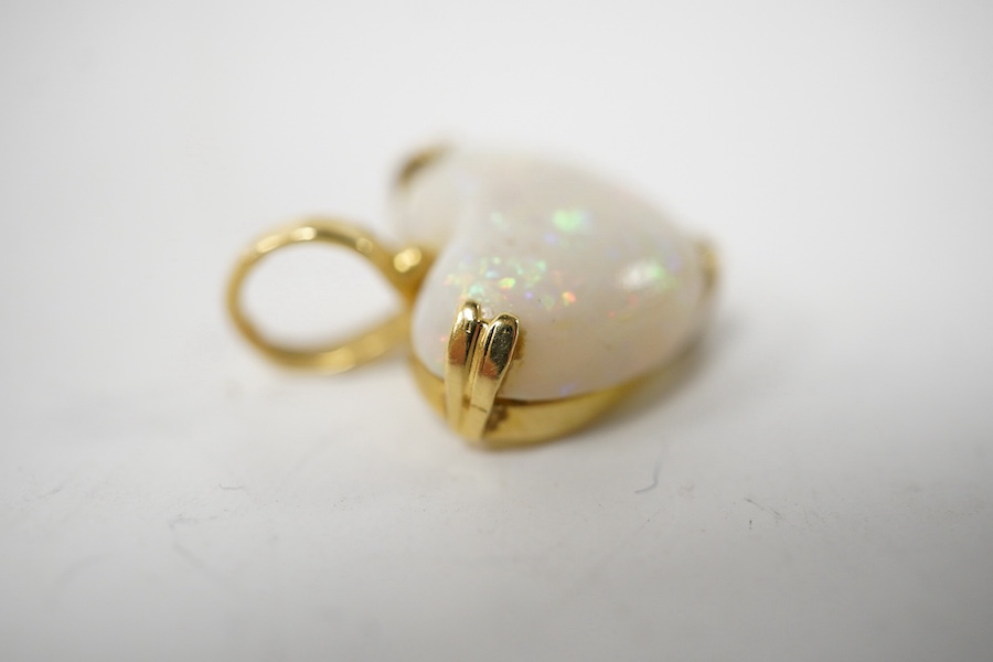 A modern 18ct gold mounted heart shaped white opal pendant, overall 20mm, gross weight 3.2 grams. Condition - fair to good